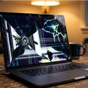 Laptop on a desk with a cracked monitor screen